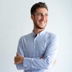 Cheerful businessman enjoying success. Young man in office shirt folding arms, looking away and smiling. Business success concept